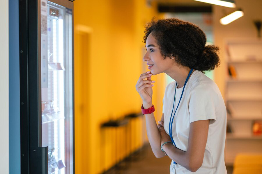 looking-snack-young-woman-choosing-something-from-fridge-office-canteen_259150-68080