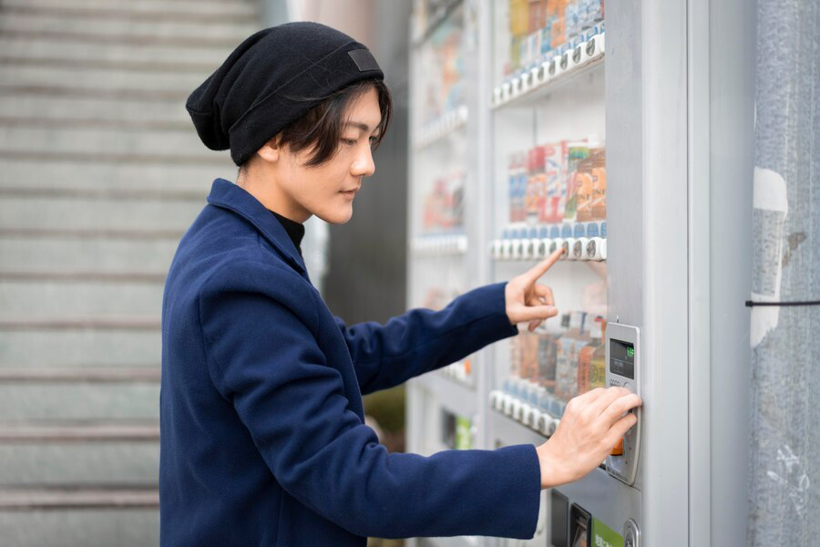 side-view-man-ordering-from-vending-machine_23-2148749304